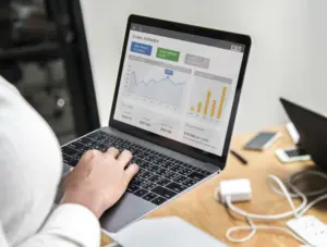 Marketing professional working on laptop for digital campaign strategy